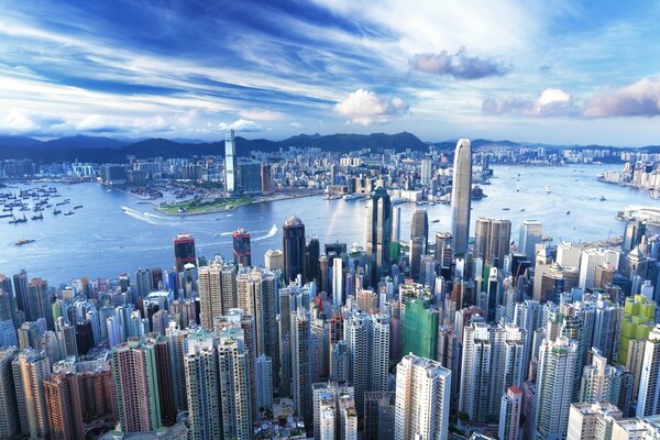 Skyscrapers of Hong Kong on the shore. The clouds