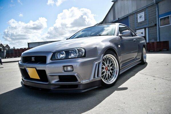 Nissan Skyline silver car in the shade with clouds