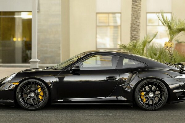 Sporty Porsche 911 on the background of the house