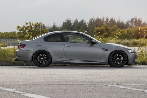 Grey BMW m3 on the background of the forest