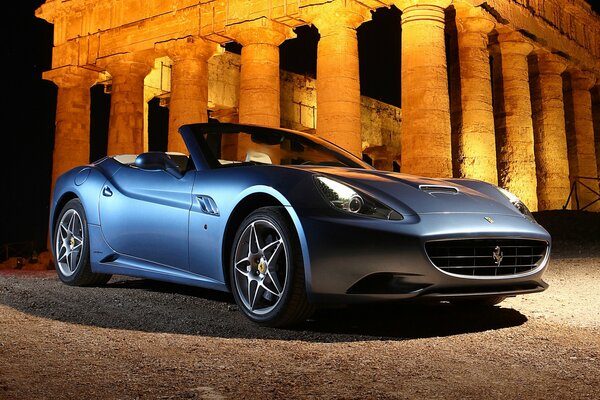 Ferrari on the background of an antique amphitheater illuminated columns