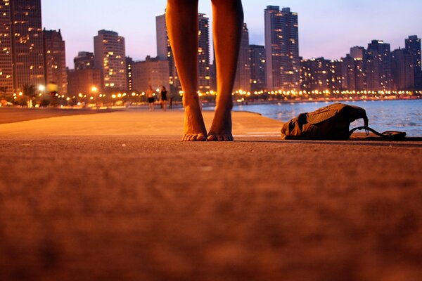 Barefoot on the evening street along the coast