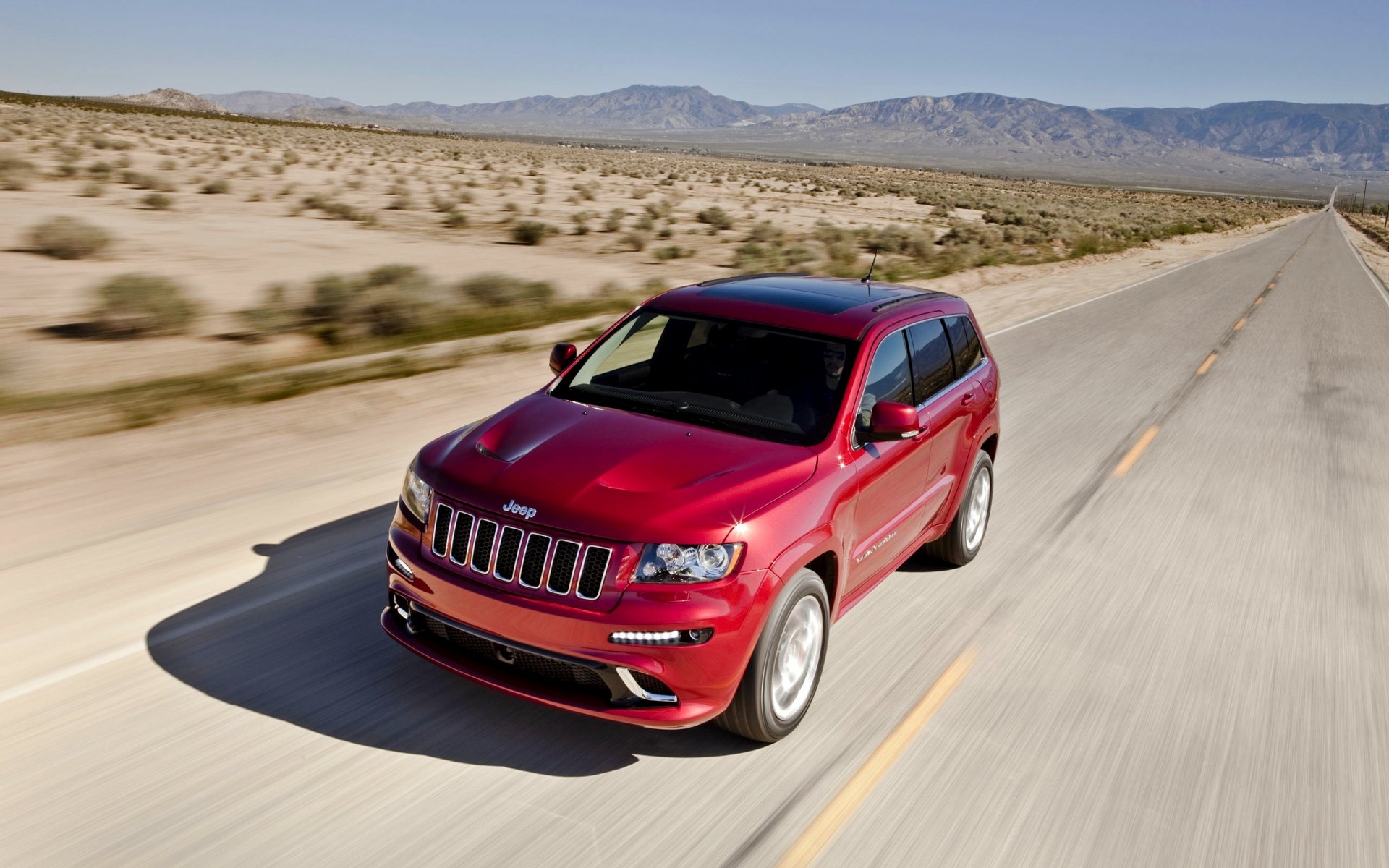 jeep grand cherokee front red road day in motion machine suv