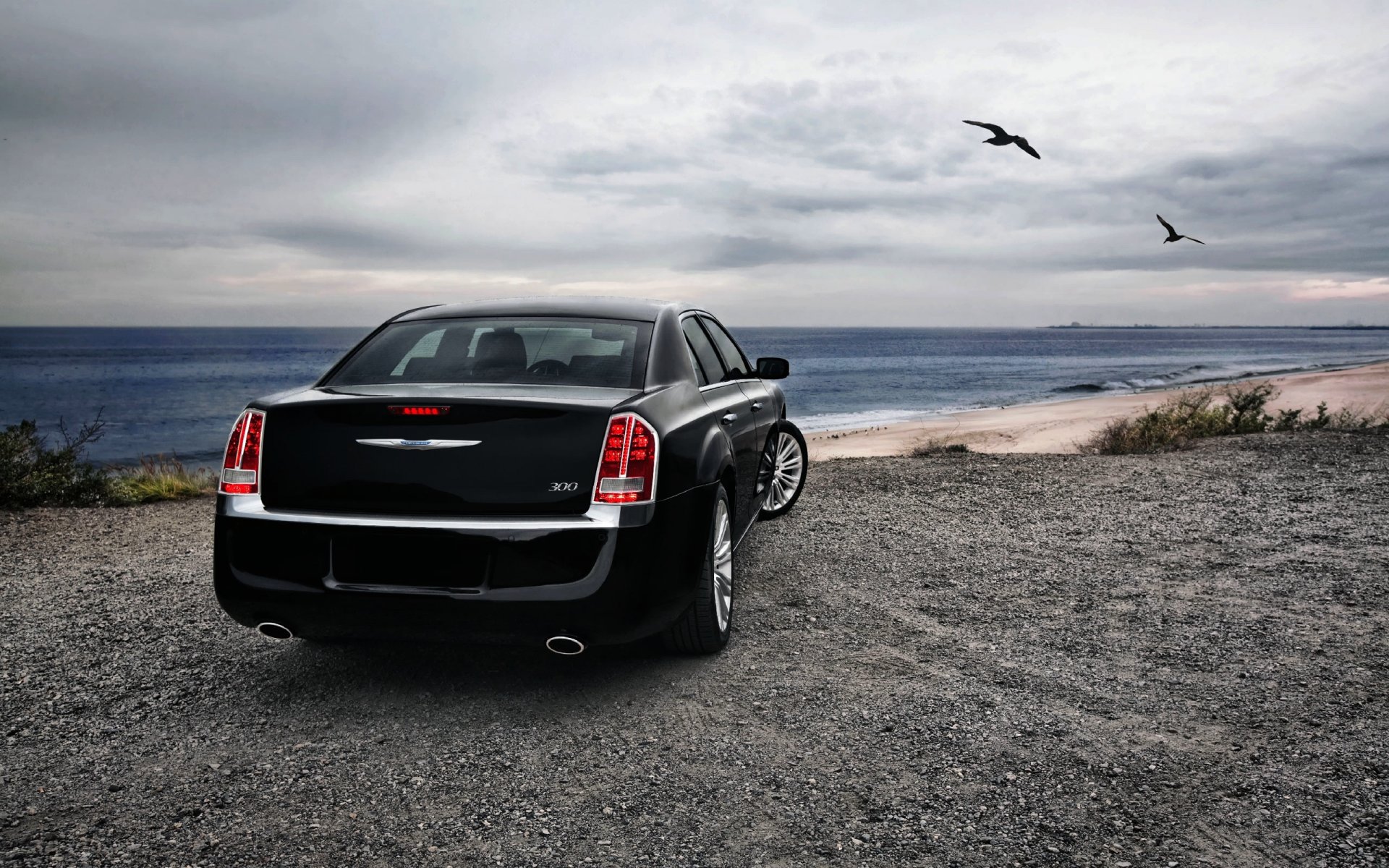 chrysler black car sedan sea coast rain