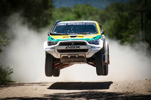 Mitsubishi SUV in the air at speed at the Dakar race
