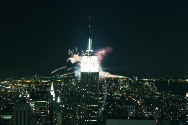 A shot of a beautiful night city with fireworks and lights from houses and cars