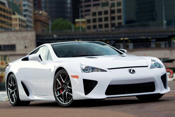 A picture of a white lexus lfa car in the city