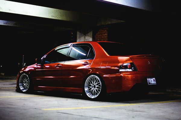 Red Mitsubishi car in the garage