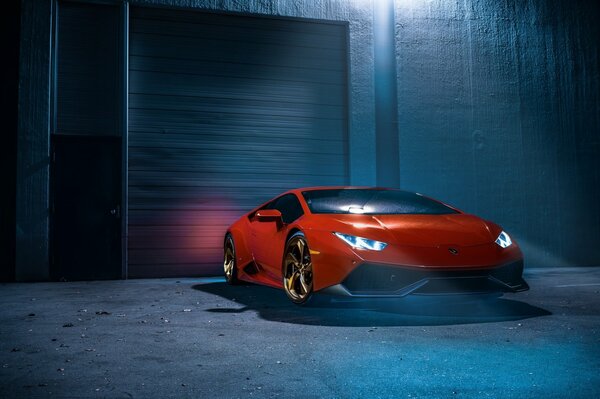 Red Lamborghini with headlights on