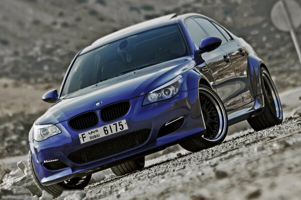 BMW M5 Tuned se encuentra en el lado de la carretera con escombros