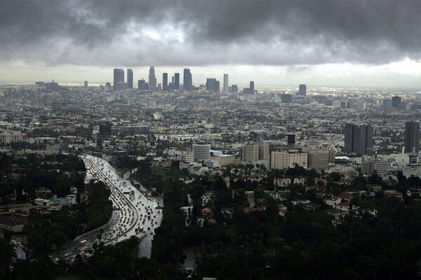 The sky is frowning over the wet asphalt of the roads of the metropolis