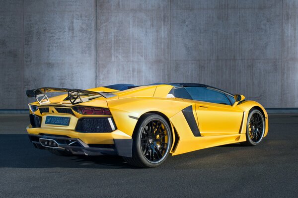 Yellow Lamborghini aventador is standing backwards