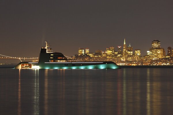 Seper mega yacht in the evening lights at the bridge