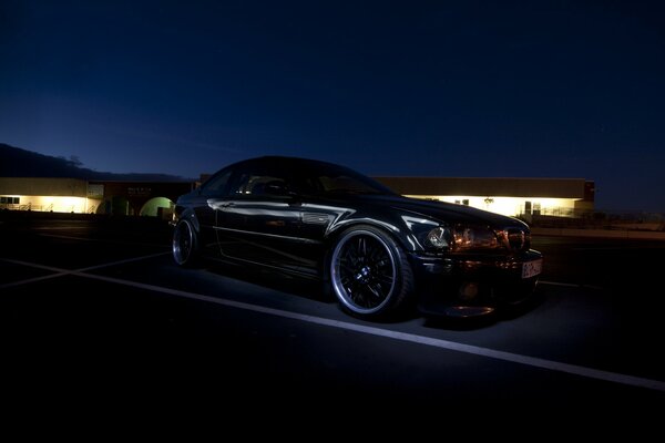 Black, tuned BMW, in the night