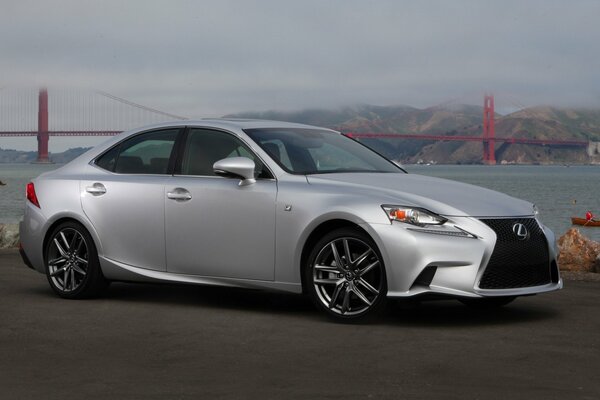 Lexus in the fog on the shore by the bridge