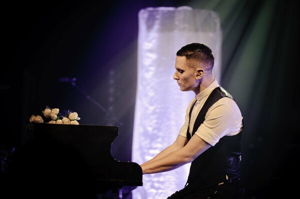 A handsome guy plays the piano