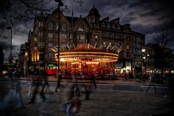 Night carousel in lights on the city street