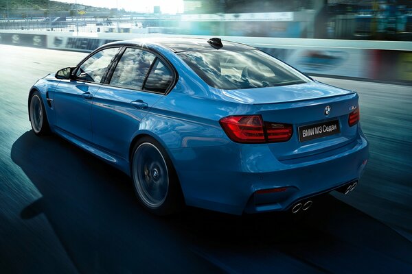 Blue BMW car rides on the race road