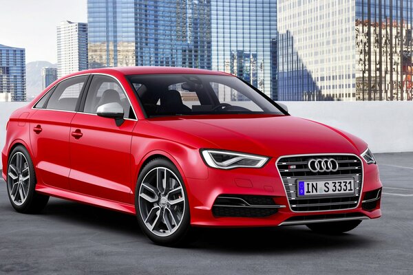 Red Audi sedan on the background of the city