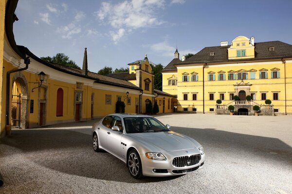 Maserati quattroporte car in silver color in the yard of the house