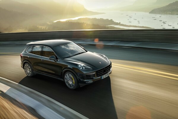 Porsche rides on the highway, in the afternoon in the mountains