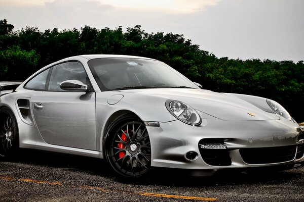 Car. Silver Porsche at sunset