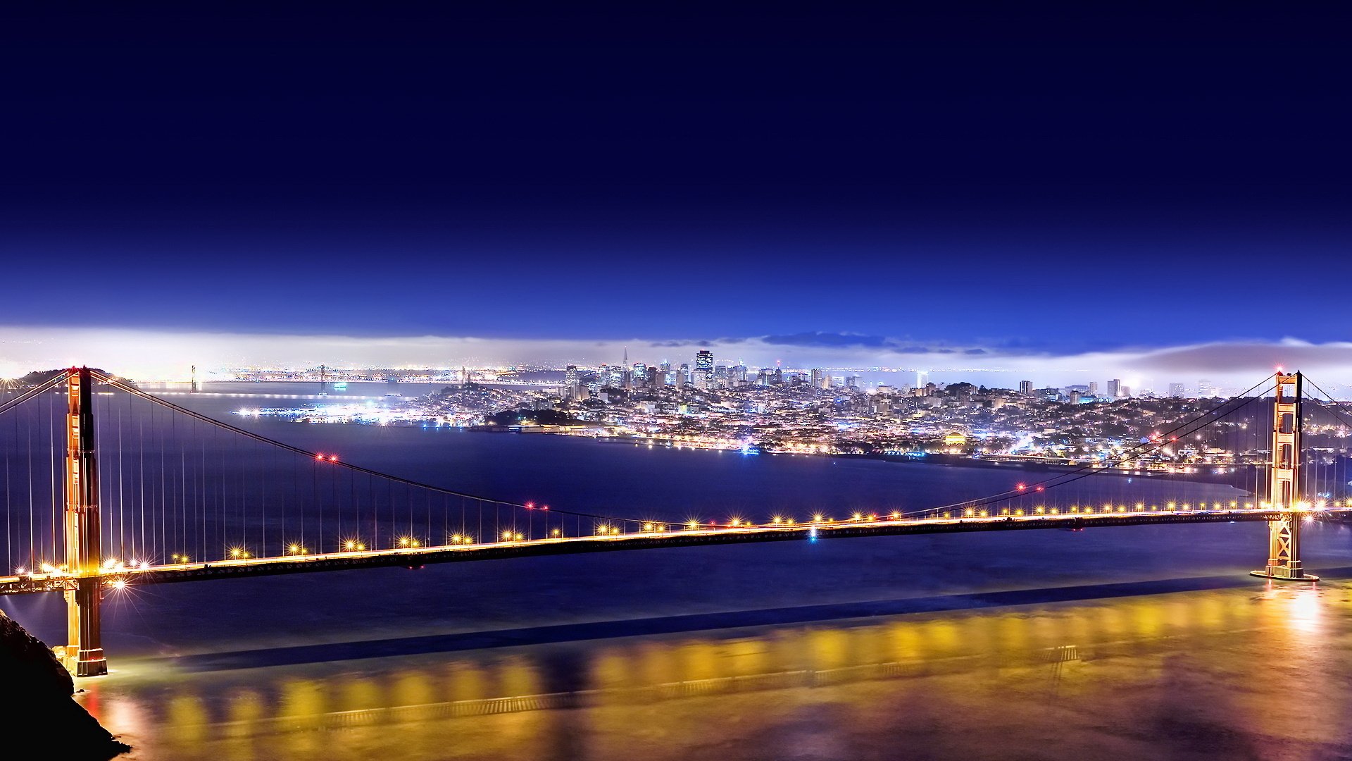 bridge the city lights river water promenade reflection skyscrapers new york background the night sky night the lights of the city. bridge