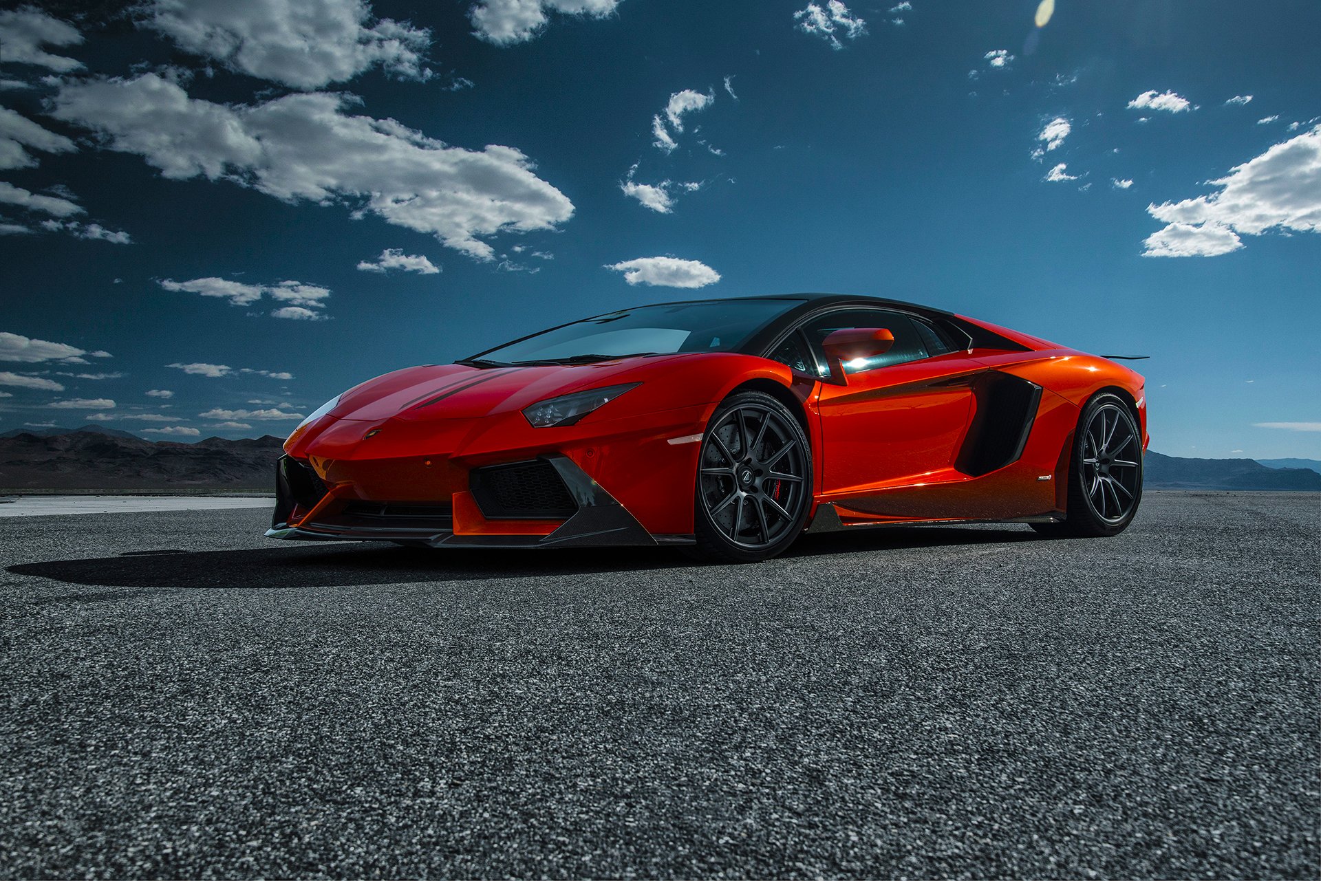 lamborghini aventador-v lp740-4 saragossa vorsteiner supersamochód pomarańczowy przód pustynia niebo chmury