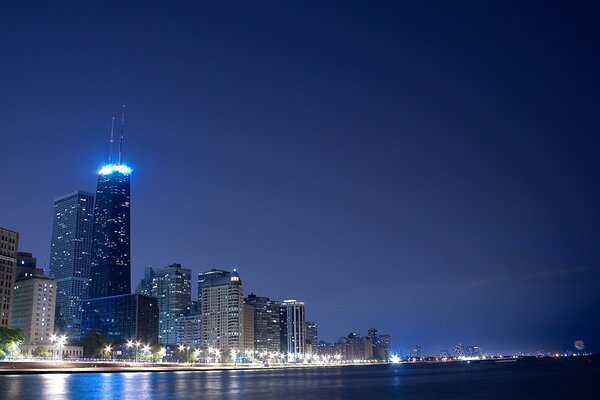 A night city with skyscrapers and lights over the river