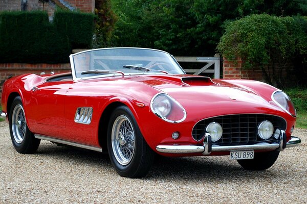 A retro car is parked in an English village