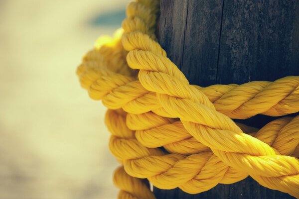 Yellow strong rope tied around the pole