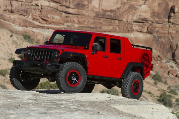 The concept of a bright red jeep wrangler red rock