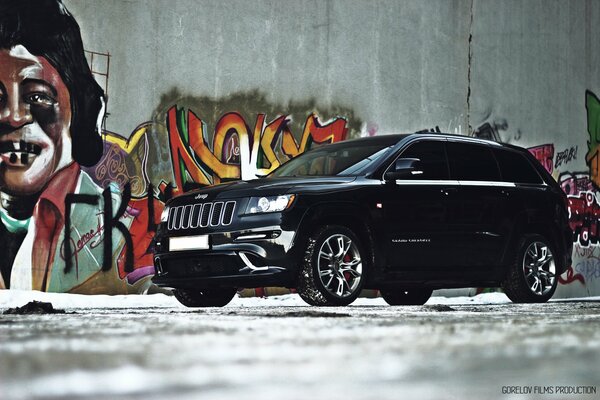 Jeep grand cherokee noir et graffiti sur le mur