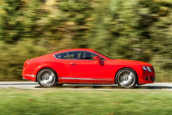 Red Bentley on a blurry background in motion