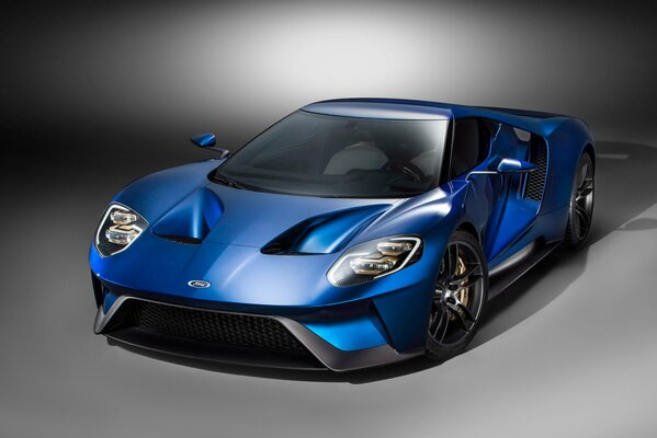 Blue ford gt half-side on gray background