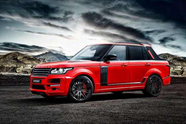 Range Rover rouge sous le ciel de plomb