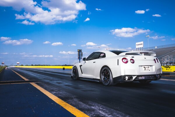 Nissan white car against the sky