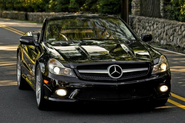 Mercedes black car on the road