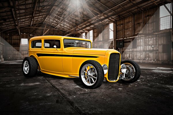 Classic yellow retro hot rod car in the hangar