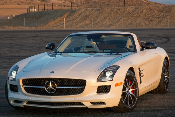 Mercedes Benz white car on the background of mountains