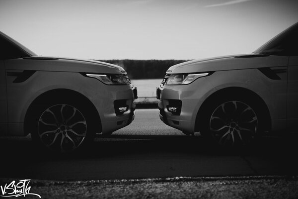 Two white cars in front of each other