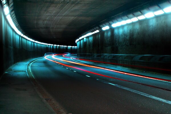 Camino en el túnel iluminado con luces