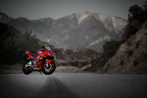 Red motorcycle on a mountain background