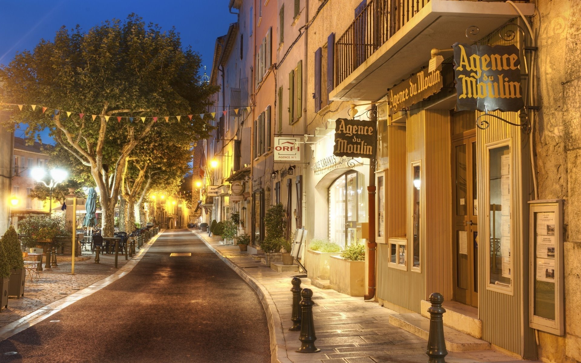 treet trees evening lanterns signs sidewalk lights flags shop windows shops cities night city light