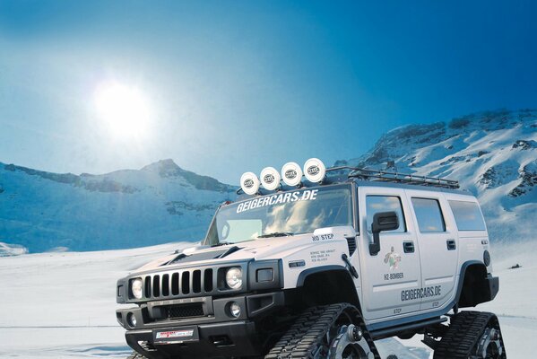 SUV hummer con orugas en lugar de ruedas en la nieve