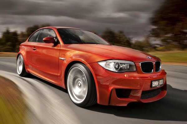 Beautiful red BMW car in motion on the road