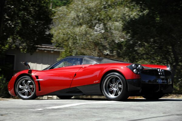 Red supercar pagani huayra on the street