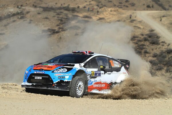 Ford fiesta on a racing rally in the dust