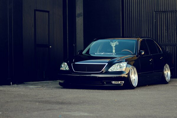 Stylish black Lexus in a dark hangar