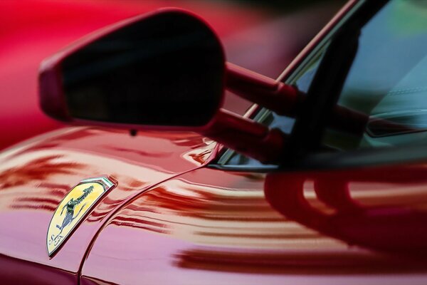 Red Ferrari mirror with dark glasses